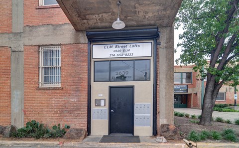 a building with a black door and a white sign that says ell street lofts